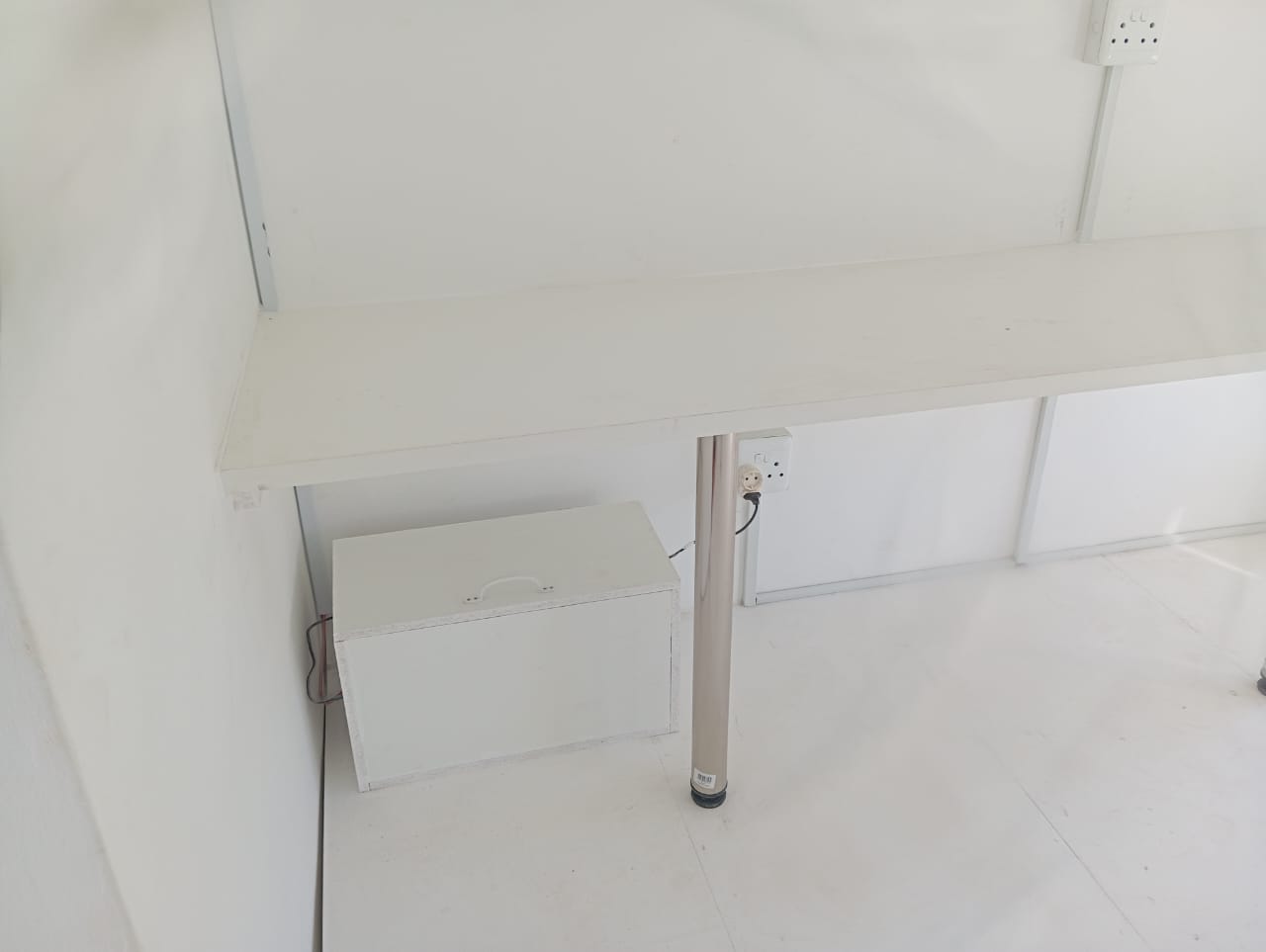 Close-up of cabinet under left wall mounted desk